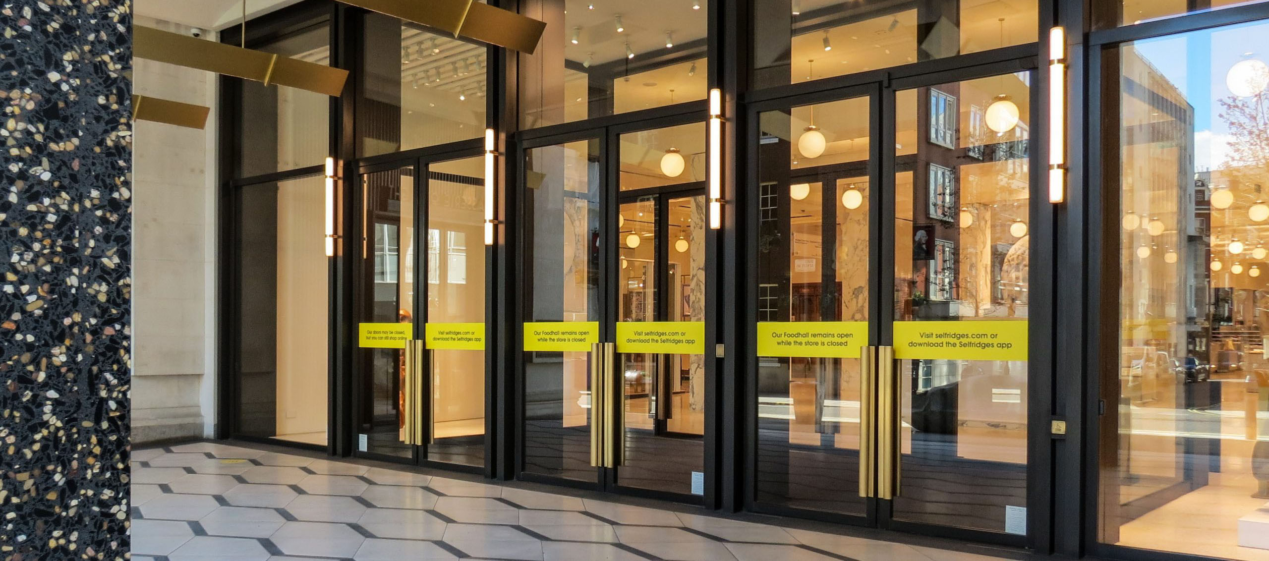 Doors at Selfridges London, illustrating an example of bronze maintenance of buildings.