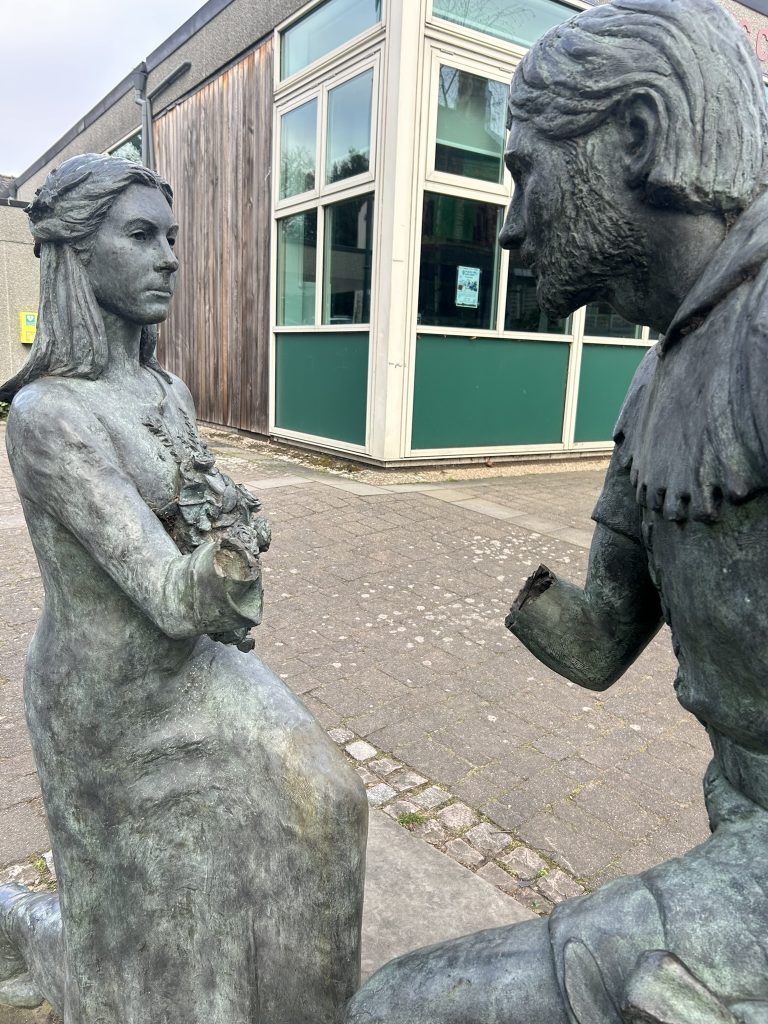 Damaged bronze sculpture of Maid Marion and Robin Hood in Edwinstowe, Nottinghamshire, with arms torn off and awaiting statue repair